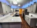 Updated kitchen with granite countertops, stainless appliances and blue accent lighting at 3216 S Granby Way, Aurora, CO 80014