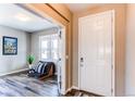 Bright entryway with a white front door and a view into the cozy office space at 1902 Pioneer Cir, Lafayette, CO 80026
