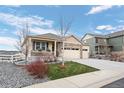 Inviting single-Gathering home featuring a covered porch and a well-manicured lawn at 2080 Shadow Creek Dr, Castle Rock, CO 80104