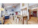 Open-concept space with vaulted ceilings, wood floors and great natural light at 11666 W 74Th Way, Arvada, CO 80005