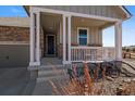 Inviting front porch with stylish columns and a charming entrance, surrounded by decorative elements at 5752 Eldorado Cir, Elizabeth, CO 80107