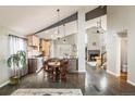 Open-concept living and dining area featuring vaulted ceilings and hardwood floors at 9094 W 103Rd Ave, Broomfield, CO 80021