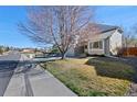 Charming two-story home with a well-maintained lawn, a tree, and an attached two-car garage at 5434 S Ward Way, Littleton, CO 80127