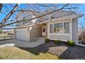 Charming two-story home with a well-maintained lawn, a tree, and an attached two-car garage at 5434 S Ward Way, Littleton, CO 80127