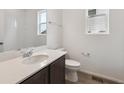 Bright bathroom featuring tile floors, a white quartz countertop, and a dark vanity at 6625 N Nepal St, Aurora, CO 80019