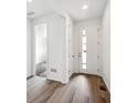 Bright entryway featuring wood floors, white walls, a closet, and a door with a glass panel at 6625 N Nepal St, Aurora, CO 80019