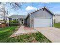 Well-maintained home with lush lawn and landscaping, featuring a two-car garage and welcoming entrance at 8896 W Teton Cir, Littleton, CO 80128