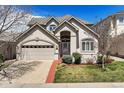 Charming home featuring a well-manicured lawn, two-car garage and neutral colored stucco facade at 4373 E Phillips Pl, Centennial, CO 80122