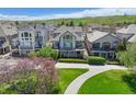 Rear exterior view featuring balconies, patios, and lush landscaping at 4373 E Phillips Pl, Centennial, CO 80122