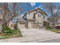 Two-story home featuring a two car garage and well-maintained lawn, with a blue sky at 2229 Hyacinth Rd, Highlands Ranch, CO 80129