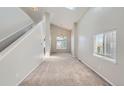 Bright living room featuring high ceilings, neutral paint, carpet and oversized windows at 2229 Hyacinth Rd, Highlands Ranch, CO 80129