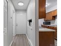 Bright condo entryway with wood-look floors and kitchen access at 14780 E Kentucky Dr # 414, Aurora, CO 80012
