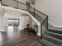 Modern staircase with iron railing and hardwood floors, creating an inviting and contemporary ambiance at 730 Edenborn Pl, Castle Rock, CO 80104