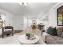 Spacious living area with a view of the kitchen and dining space, perfect for entertaining at 9587 W 89Th Cir, Broomfield, CO 80021