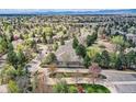 Scenic aerial view of a residential neighborhood with tree-lined streets and mountain views in the distance at 1 Silver Fox Dr, Greenwood Village, CO 80121