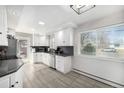 Updated kitchen featuring white cabinetry, stainless steel appliances, and sleek countertops at 13000 Willow Ln, Golden, CO 80401