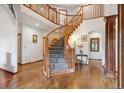 Elegant foyer featuring a grand staircase, hardwood floors, and sophisticated design elements at 19595 E Top O The Moor Dr, Monument, CO 80132