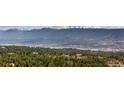 Expansive mountain views framed by lush greenery and nestled among luxury homes at 19595 E Top O The Moor Dr, Monument, CO 80132
