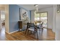 Charming dining area with stylish lighting and a sliding glass door to the backyard at 6020 Quail St, Arvada, CO 80004