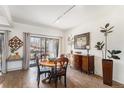 Bright dining area featuring wood floors, a round table, and sliding glass doors to the outdoor patio at 7250 Eastmoor Dr # 203, Denver, CO 80237