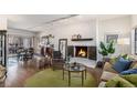 Cozy living room boasts a fireplace and an open floor plan into dining area at 7250 Eastmoor Dr # 203, Denver, CO 80237
