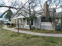 Well-maintained home with gray siding, brick accents, and a neatly landscaped yard at 3011 W Long Ct # F, Littleton, CO 80120