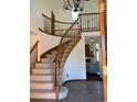 Grand foyer with a curved staircase, wood railings, and tile flooring at 16119 E Prentice Ln, Centennial, CO 80015