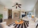 Bright living room featuring hardwood floors, fireplace, and stylish decor at 2258 Whistler Dr, Longmont, CO 80504