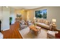 Virtually staged living room with hardwood floors and neutral furniture at 750 Tabor St # 18, Lakewood, CO 80401