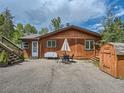 Cozy home with a welcoming front yard, dining set, and convenient storage shed at 12348 Quartz Spur, Conifer, CO 80433