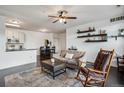 Open-concept living space with hardwood floors and a smooth transition to the kitchen and dining area at 14221 E 1St Dr # 208, Aurora, CO 80011