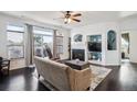 Cozy living room featuring a fireplace, built-in shelving, and a sliding glass door with balcony access at 14221 E 1St Dr # 208, Aurora, CO 80011