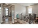 Spacious foyer featuring wood floors, an elegant staircase, and natural light at 8548 S Quatar St, Aurora, CO 80016