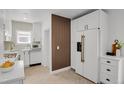 Modern white kitchen with stainless steel appliances and ample cabinet space at 1455 Hudson St, Denver, CO 80220
