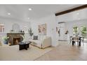 Bright living room with a fireplace, herringbone floors, and an open concept to the kitchen at 1455 Hudson St, Denver, CO 80220
