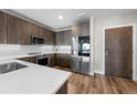 Contemporary kitchen with stainless steel appliances, sleek cabinetry, white countertops, and modern design elements at 20 Wilcox St # 318, Castle Rock, CO 80104