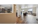 Inviting living room showcases an open floor plan, seamlessly connecting to the kitchen and dining areas at 5218 E 100Th Pl, Thornton, CO 80229