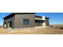 Exterior view of the modern home showcasing its unique design and newly installed sidewalk at 65960 E Evans Pl, Byers, CO 80103