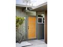 Modern front door with sleek design and contemporary hardware, complemented by stylish house numbers at 1459 S Filbert Way, Denver, CO 80222