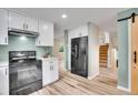 Updated kitchen features stainless steel appliances, white cabinetry, and modern countertops at 2140 W 135Th Ave, Westminster, CO 80234