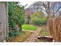 Landscaped backyard with brick path and a storage shed at 1333 S Eudora St, Denver, CO 80222