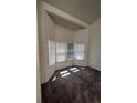 Bright bedroom with a bay window providing natural light and neutral carpet at 15983 E Loyola Dr, Aurora, CO 80013