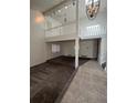 Open-concept living room with a loft area and neutral-toned carpet and tile flooring at 15983 E Loyola Dr, Aurora, CO 80013