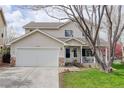 Charming home with an attached garage, covered porch, and well-maintained lawn at 19058 E Hickock Dr, Parker, CO 80134