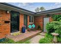Inviting front porch with brick pavers, bench seating, and a colorful flower arrangement at 2041 W Briarwood Ave, Littleton, CO 80120