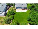 Large, green backyard with a concrete patio, mature trees, and wooden fence at 7270 S Cherry Dr, Centennial, CO 80122