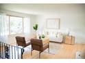 Bright living room features hardwood floors, large window and modern décor at 7270 S Cherry Dr, Centennial, CO 80122