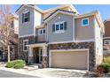 Charming two-story home features a stone facade, attached garage, and a cozy front porch at 10120 Fenwick St, Parker, CO 80134