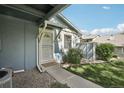 Welcoming front entrance with a 'welcome' mat and well-maintained landscaping at 12115 Bannock St # B, Denver, CO 80234