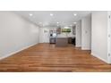 Bright living room features beautiful hardwood floors and plenty of natural light at 6103 Uno St, Arvada, CO 80003
